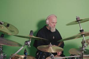 Father Maximilian Mary Dean playing drums in his studio.