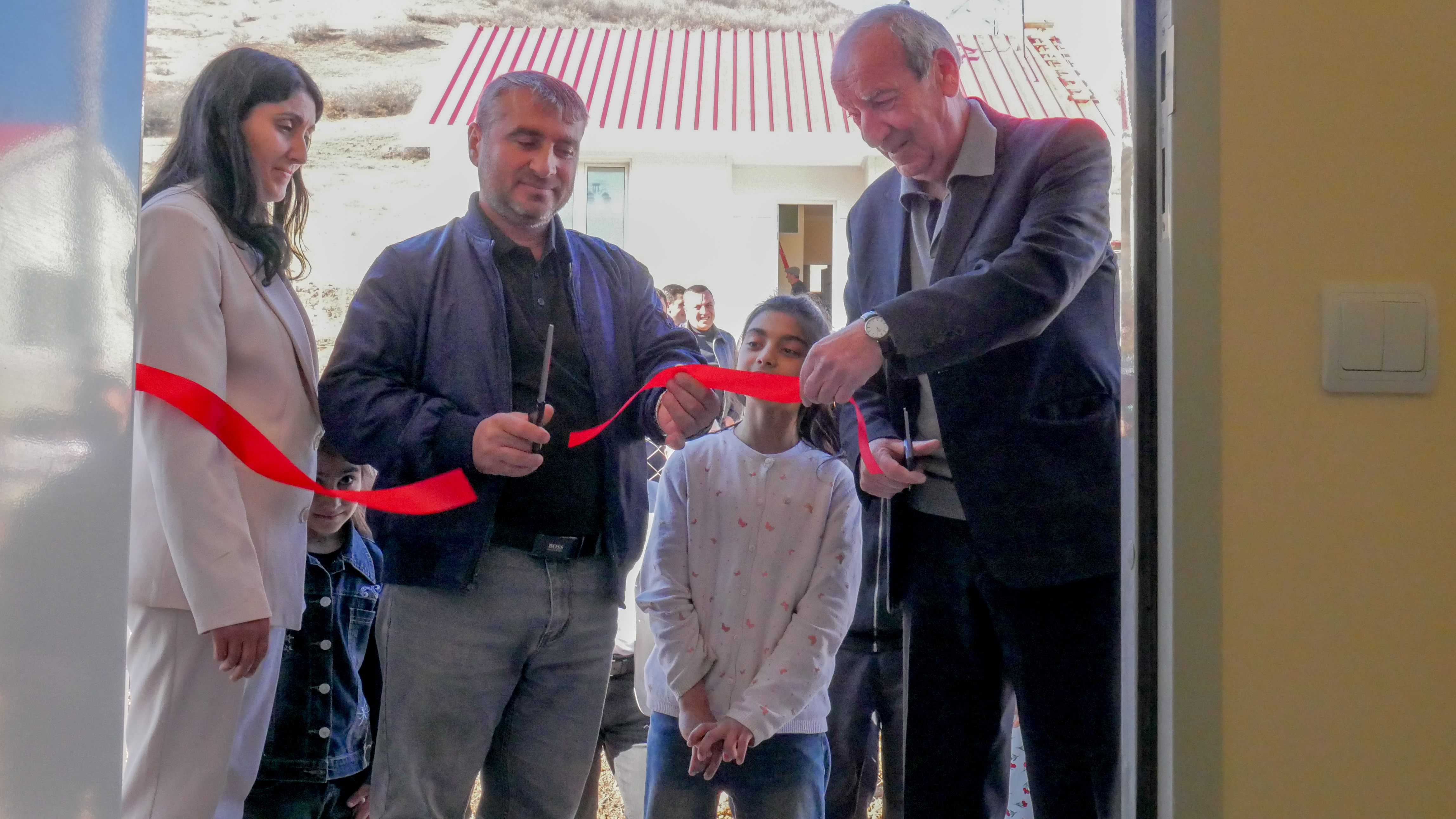 Una familia corta la cinta roja de su nuevo hogar el 18 de noviembre de 2025.