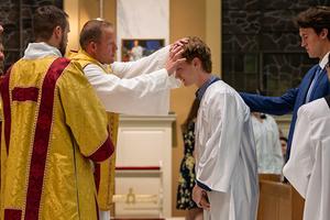 Father Lee receiving Aidan Brynjelsen into the Church. 