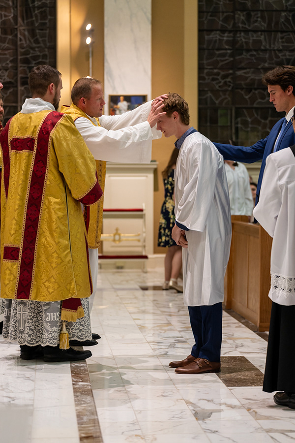 Father Lee receiving Aidan Brynjelsen into the Church. 