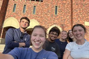 Recent Catholic convert Ashwin Mannur, center in glasses, smiles with friends from the UNL Newman Center.