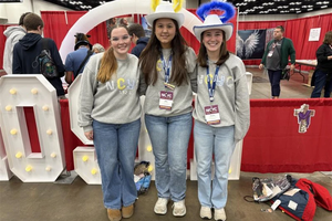 Lucy Snipes, Anne Young, and Presley Hilderbrand from Columbus, Georgia tour exhibits during the first night of NCYC 2025 on Nov. 20, 2025, at the Indiana Convention Center in Indianapolis.