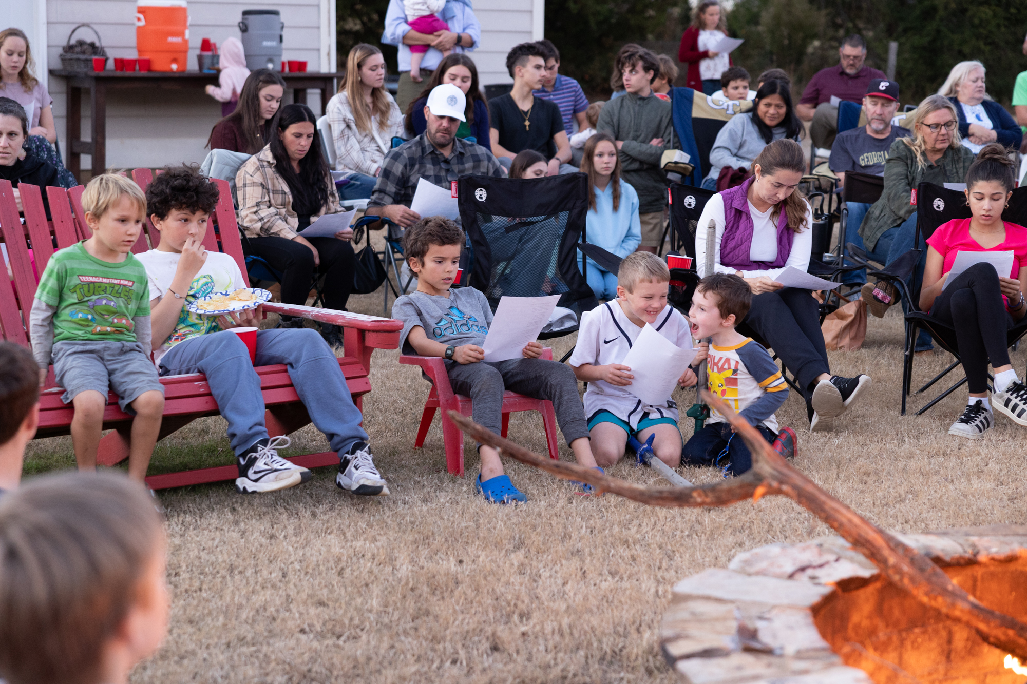 Catholics gather around the campfire for the monthly Rosary at the Billings' house. 