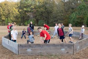 Kids play a game during an evening gathering to pray the Rosary at Kathleen Billings' home and farm.