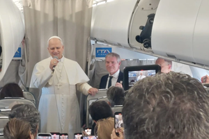 Pope Leo XIV talks to reporters during his flight to Lebanon on Nov. 30, 2025.