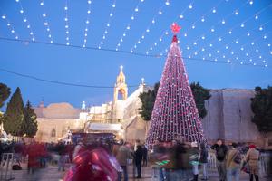 People gathers at manger Square with a giant Christmas tree to celebrate the Christmas Eve in 2017.