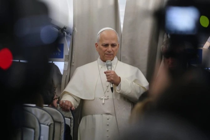 Pope Leo XIV speaks with reporters on his flight from Beirut to Rome on Dec. 2, 2025. 