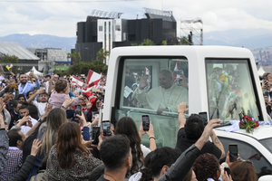 Pope Leo XIV interacts with a baby before celebrating Mass in Beirut, Lebanon, on Dec. 2, 2025.