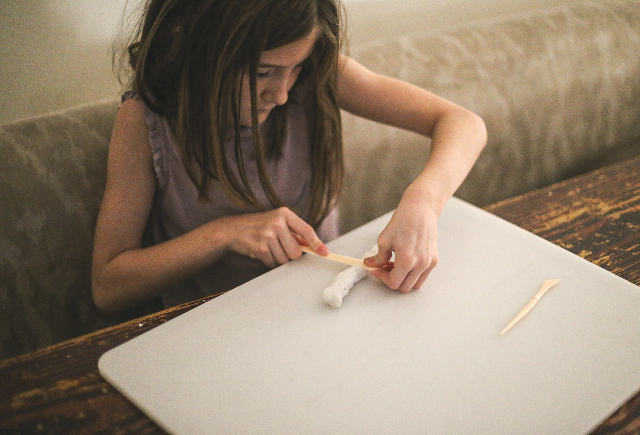 Rolling the clay into shapes. 