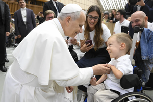 Pope Leo XIV greets sick and disabled people, including a young child in a wheelchair, in the Vatican’s Paul VI Hall after the Wednesday general audience on Sept. 10, 2025.