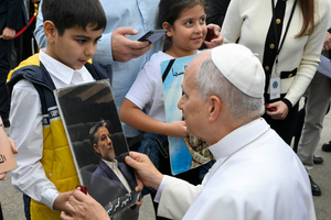 Pope Leo XIV greets a young child at the site of the Aug. 4, 2020, blast at the Port of Beirut on Dec. 2, 2025. 