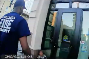 Chicago firefighters attend to a woman outside a doorway in video taken in November 2025 by Coalition Life.
