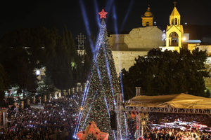 Spectators gather in Nativity Square during a Christmas tree lighting ceremony in Bethlehem on Dec. 6, 2025.