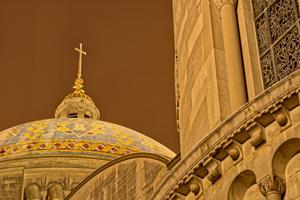 The Basilica of the National Shrine of the Immaculate Conception in Washington, D.C., stands illuminated at midnight on a winter night.