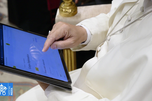 Pope Leo XIV uses a tablet to navigate the website of the new digital version of the Vatican's Pontifical Yearbook, known as the Annuario Pontificio in Italian.