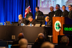 The plenary assembly of the U.S. Conference of Catholic Bishops gets underway on Nov. 11, 2025, at the Baltimore Marriott Waterfront. First row, left to right: Father Michael Fuller, general secretary; Archbishop Timothy Broglio, president, and Archbishop William Lori, vice president.