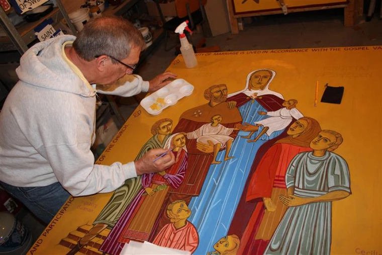 Father Richard Reiser, an iconographer based in Omaha, Nebraska, writes an icon of St. Bridget of Sweden with her family for FOCCUS Marriage Ministries’ 40th anniversary.