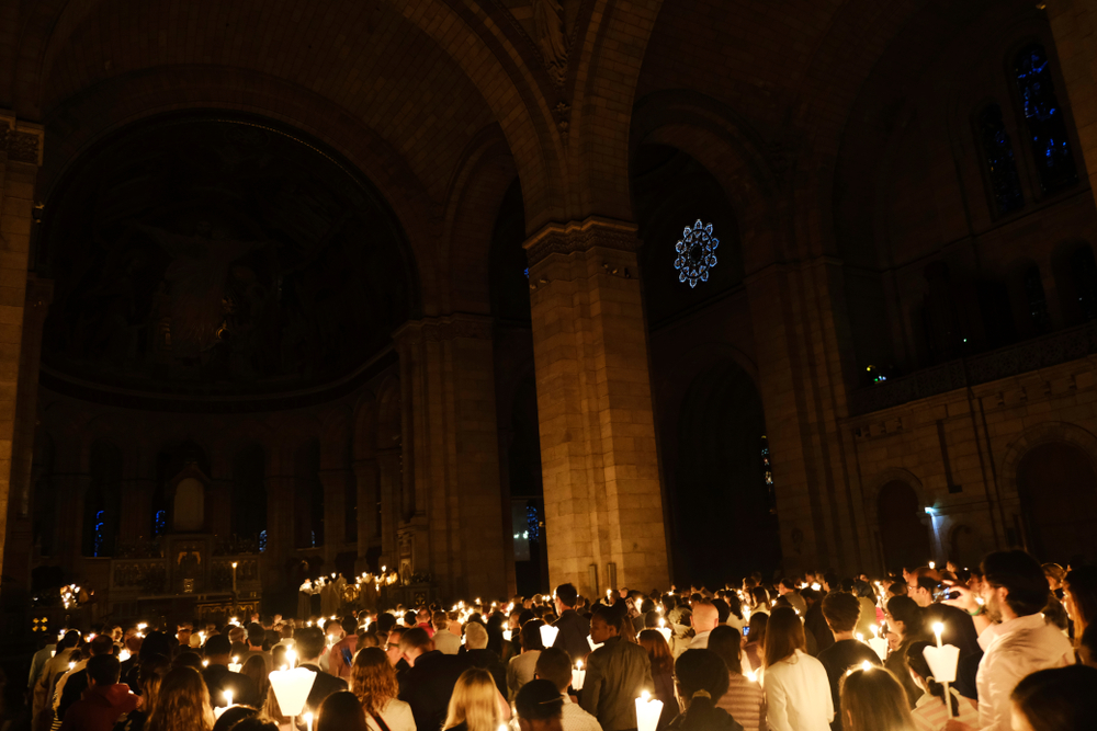 Worshipers hold candles during an Easter vigil mass in the Basilica of the Sacred Heart of Paris, France on Apr. 20, 2019
