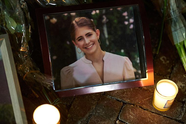 Candles are lit by a framed photo of mass-shooting victim Ella Cook at a makeshift memorial near Brown University in Providence, Rhode Island, on Dec. 15, 2025.