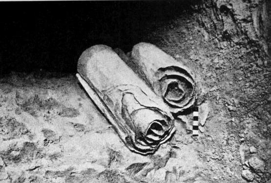 Qumran scrolls (WC): Two scrolls from the Dead Sea Scrolls lie at their location in the Qumran Caves before being removed for scholarly examination by archaeologists. (Photo: Public Domain via Wikimedia Commons)