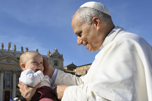 Pope Leo XIV blesses a baby on All Saints Day’ 2025.