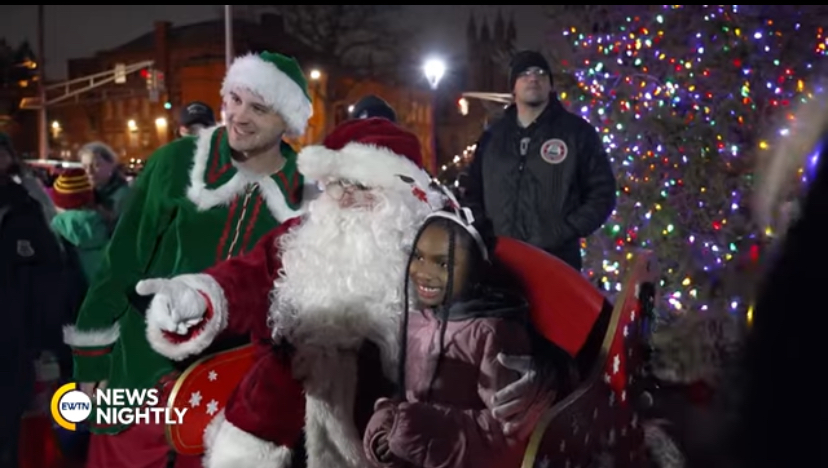 Children pose for a picture with Santa Claus.
