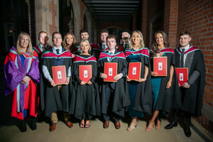 Graduates pose with their degrees at St. Mary’s University College in Belfast, Northern Ireland.
