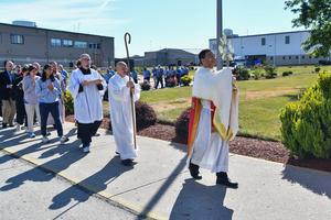 Bishop Earl Fernandes of Columbus, Ohio, carries the Blessed Sacrament during a procession at Pickaway Correctional Institution on June 28, 2024, at one of the stops on the Seton Route of the National Eucharistic Pilgrimage.