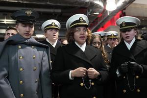 Joshua Delgado, a West point cadet and Knight, prays the Rosary with Naval Academy Midshipmen Aelia Trainer and Ella Biebl, as cadets from West Point and midshipmen from the Naval Academy pray the Rosary during halftime at the 126th Army-Navy football game at M&T Bank Stadium in Baltimore on Dec. 13, 2025.