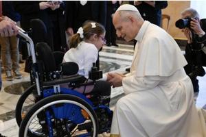 Pope Leo XIV greets a girl in a wheelchair during an audience with members of Italian Catholic Action on Dec. 19, 2025 at the Vatican.