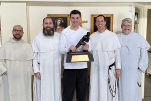 Indiana quarterback and Heisman trophy winner Fernando Mendoza brings his big win by to visit Dominican priests on Christmas Eve including Father Patrick Hyde. 