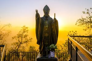 A statue of Pope St. John Paul II is seen at sunset in Santiago, Chile.