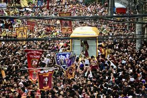 The image of the Black Nazarene moves through dense crowds during the 30-hour procession in Manila, Philippines, on Jan. 9, 2026.
