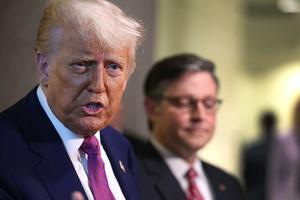 With Speaker of the House Mike Johnson by his side, President Donald Trump speaks to the press following a House Republican meeting at the U.S. Capitol on May 20, 2025, in Washington, D.C.