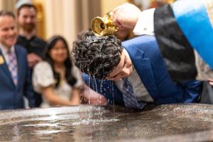 A student is baptized during the Easter vigil Mass at the Basilica of the Sacred Heart on April 19, 2025.