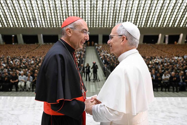 Pope Leo XIV shakes hands with Cardinal Baldassare Reina, vicar general of Rome, during a meeting with priests of the Rome Diocese at the Vatican on June 12, 2025.