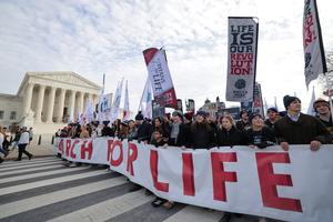 Pro-lifers march by the U.S. Supreme Court as they participate in the annual March for Life rally on Jan. 23, 2026, in Washington.