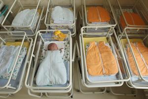 A newborn baby lies in the maternity ward of a hospital on Aug. 12, 2011, in Brandenburg, Germany.