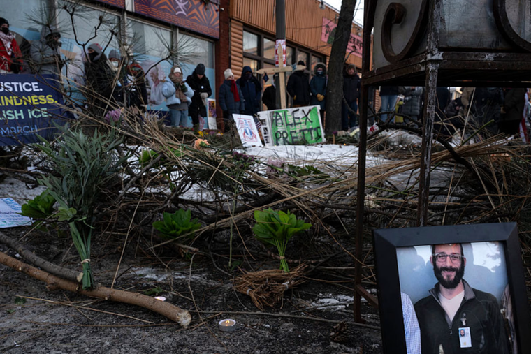 A photograph of 37-year-old Alex Pretti can be seen at a makeshift memorial in the area where he was shot dead by federal immigration agents earlier in the day in Minneapolis, Minnesota, on Jan. 24, 2026. 