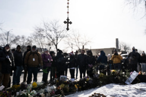 Mourners gather at a makeshift memorial on Jan. 25, 2026, in Minneapolis in the area where Alex Pretti was shot dead a day earlier by federal immigration agents. 