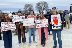 March for Life 2026 attendees carry signs that reference Scripture or popular culture.
