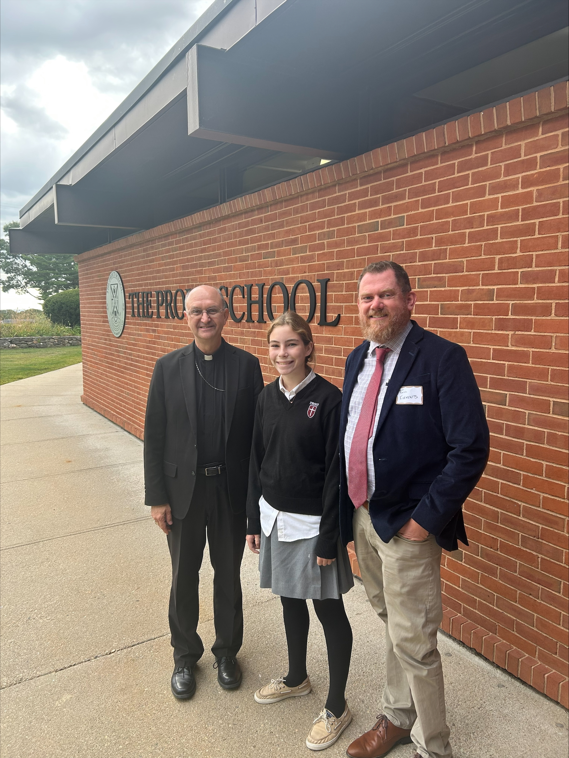 Natalie McMahon poses with Bishop Bruce Lewandowski and Bill Klements, superintendent of Catholic Schools for The Diocese of Providence.