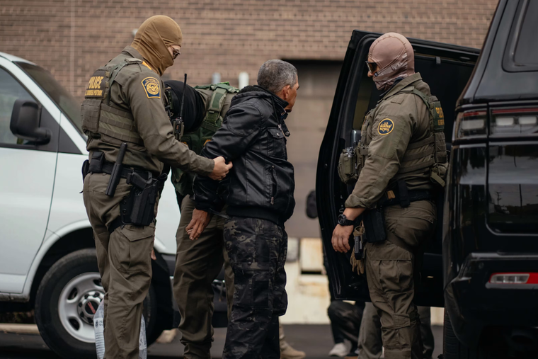 A person detained is taken to a parking lot on the far north side of the city before being transferred to an Immigration and Customs Enforcement facility in Chicago on Oct. 31, 2025. 