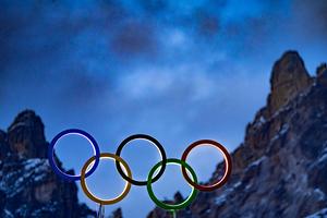The illuminated Olympic rings are seen on the roof the Olympic stadium with mountain peaks behind it in Cortina d’Ampezzo, northern Italy prior to the Milano Cortina 2026 Olympic Games, on Feb. 2, 2026.