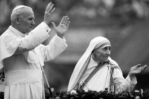Mother Teresa and Pope John Paul II greet well-wishers at the Nirmal Hriday Home in Calcutta, India, Feb. 3, 1986.