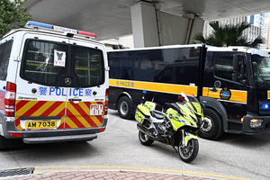 A vehicle believed to be transporting convicted pro-democracy media tycoon Jimmy Lai arrives at the West Kowloon Magistrates' court in Hong Kong on January 12, 2026.