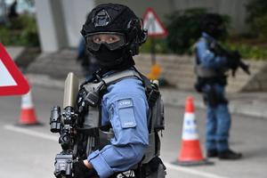 Police stand guard outside West Kowloon Magistrates’ Court in Hong Kong on Jan. 12 during sentencing arguments for pro-democracy media tycoon Jimmy Lai.