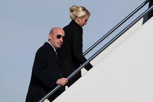 Politcal advisor Stephen Miller (L) and White House assistant to the President Natalie Harp walk up the airstairs as he boards Air Force One on January 27, 2026 at Joint Base Andrews, Maryland.  President Trump is en route to Clive, Iowa for a rally with supporters where he is expected to talk about energy and the economy in his speech.  