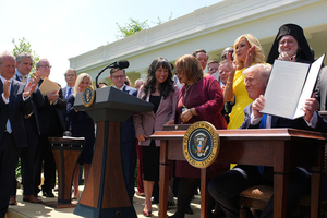 U.S. President Donald Trump, joined by lawmakers and religious leaders, signs an executive order establishing the Commission on Religious Liberty during a National Day of Prayer event in the Rose Garden at the White House on May 1, 2025, in Washington, D.C. 