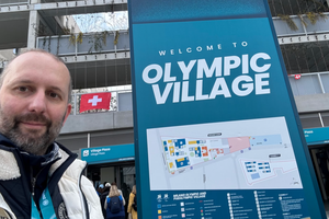 Father Oldřich Chocholáč, chaplain of the Czech Olympic team, stands at the entrance to the Olympic Village in Milan during the 2026 Winter Games in February 2026. 